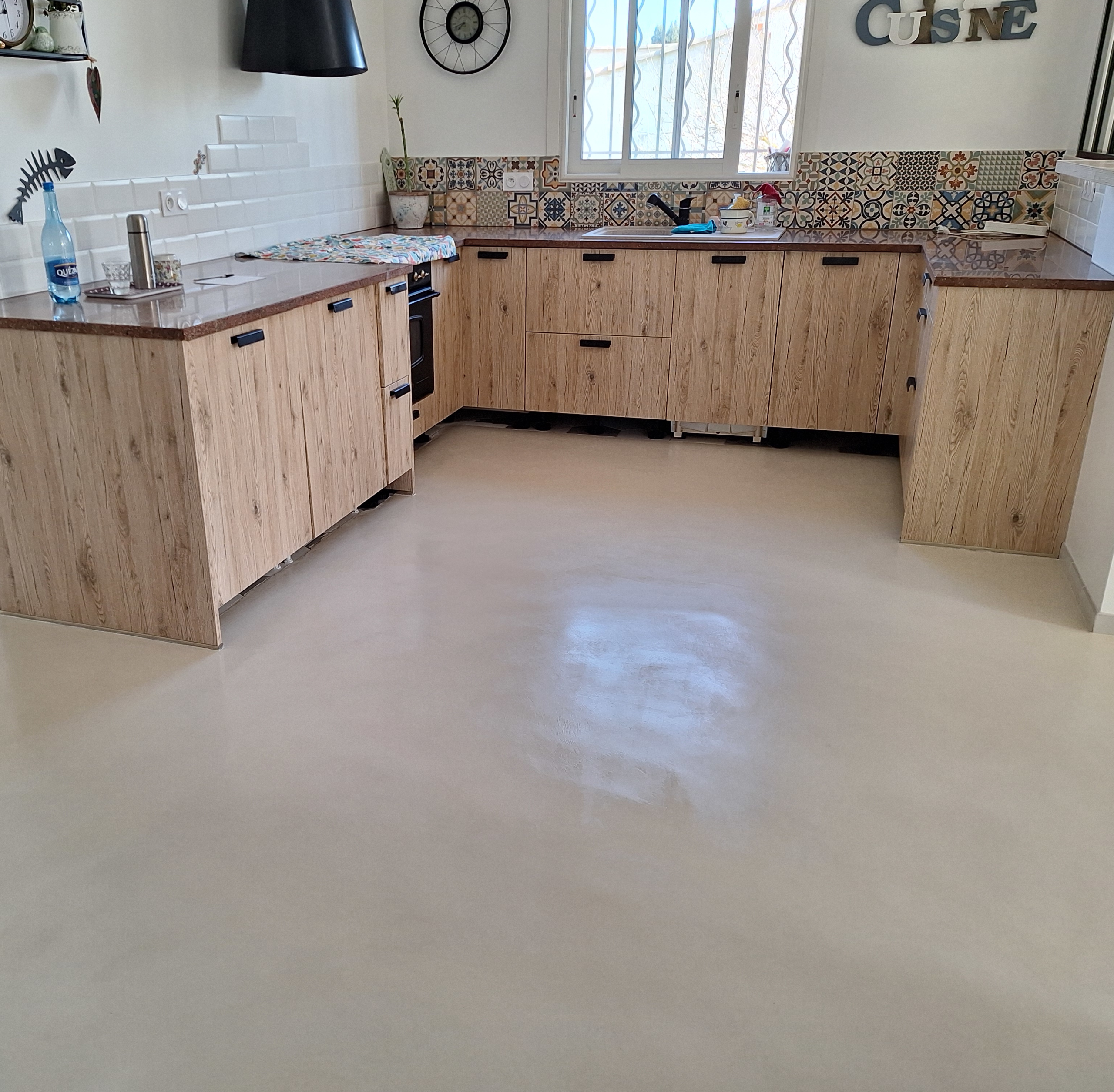 Cuisine avec sol en béton ciré clair et meubles en bois