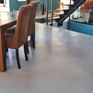 Sol en béton ciré dans une salle à manger avec chaises